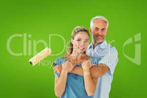 Composite image of happy couple hugging and holding paint roller