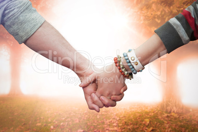 Composite image of students holding hands