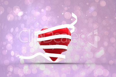 Composite image of love heart wrapped in ribbon