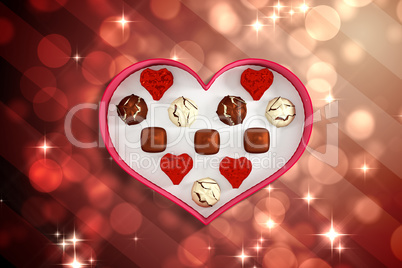 Composite image of heart shaped box of candy