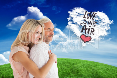 Composite image of affectionate couple standing and hugging