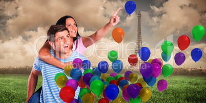 Composite image of young man giving girlfriend a piggyback ride