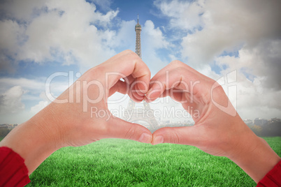 Composite image of woman making heart shape with hands