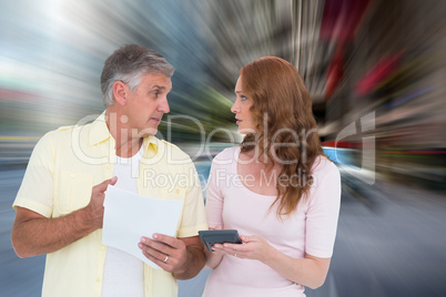 Composite image of casual couples working out their bills