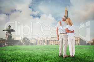 Composite image of happy couple standing and looking