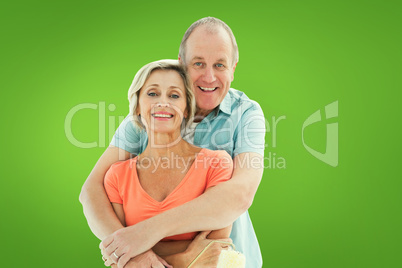 Composite image of happy older couple holding paint roller