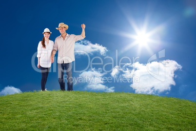 Composite image of smiling couple both wearing hats