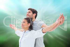 Composite image of cute couple standing with arms out