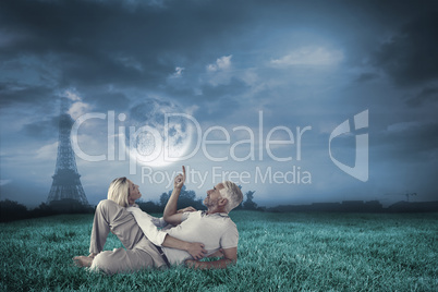 Composite image of smiling couple lying and looking up