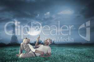 Composite image of smiling couple lying and looking up