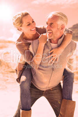 Laughing couple smiling at each other on the beach