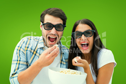 Composite image of attractive young couple watching a 3d movie