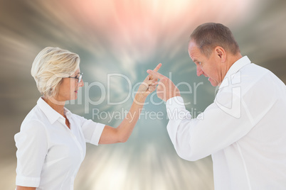 Composite image of angry older couple arguing with each other Composite image of angry older couple arguing with each other