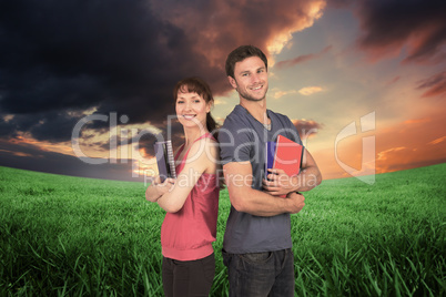 Composite image of two students both with notepads