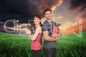 Composite image of two students both with notepads