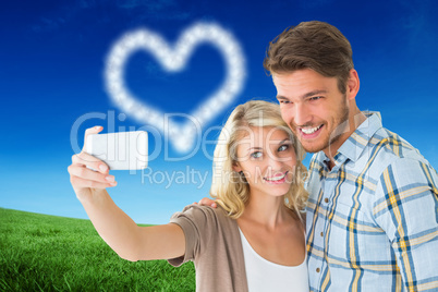 Composite image of attractive couple taking a selfie together