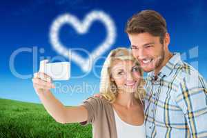 Composite image of attractive couple taking a selfie together