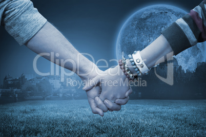 Composite image of students holding hands