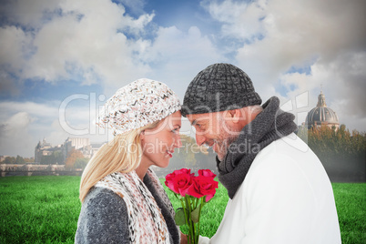 Composite image of smiling couple in winter fashion posing with