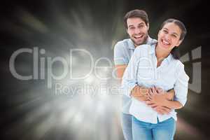 Composite image of cute couple hugging and smiling at camera