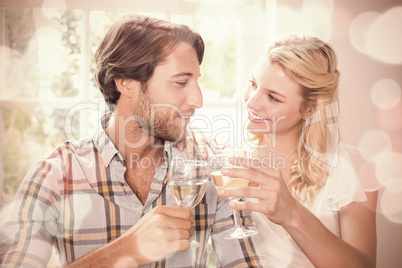 Cute smiling couple enjoying white wine together