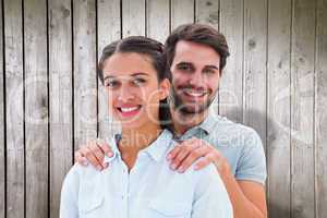 Composite image of cute couple smiling at camera