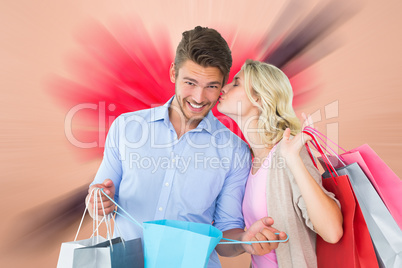 Composite image of attractive young couple holding shopping bags