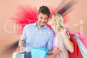 Composite image of attractive young couple holding shopping bags