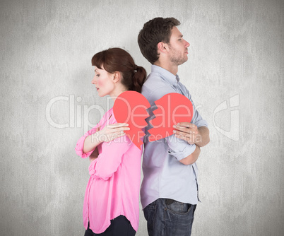 Composite image of couple holding a broken heart