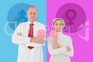 Composite image of older couple standing holding broken pink hea