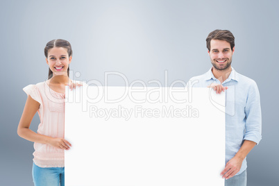 Composite image of attractive young couple smiling at camera hol