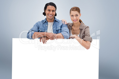 Composite image of couple leaning on blank wall