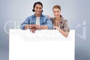 Composite image of couple leaning on blank wall