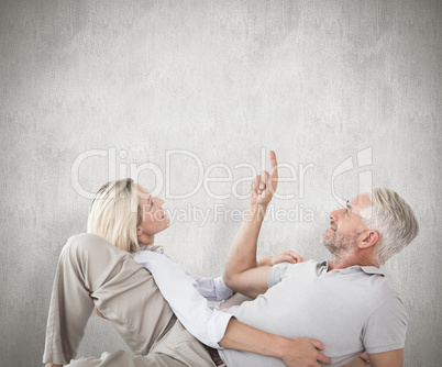 Composite image of smiling couple lying and looking up