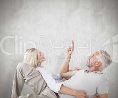 Composite image of smiling couple lying and looking up