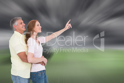 Composite image of casual couple hugging and looking