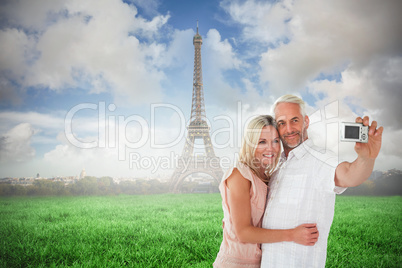 Composite image of happy couple posing for a selfie