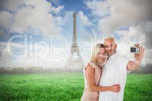 Composite image of happy couple posing for a selfie