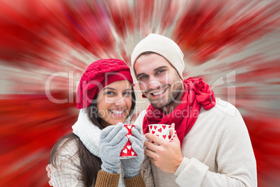 Composite image of winter couple holding mugs