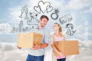 Composite image of attractive young couple carrying moving boxes