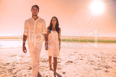 Beautiful couple holding hands and walking towards camera