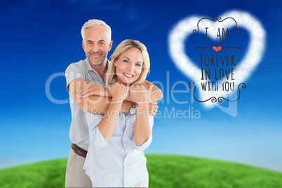 Composite image of happy couple standing and hugging