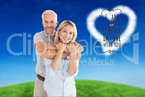 Composite image of happy couple standing and hugging