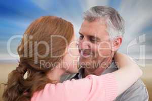 Composite image of casual couple hugging and smiling