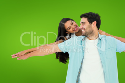 Composite image of happy casual man giving pretty girlfriend pig