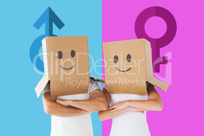 Composite image of couple wearing smiley face boxes on their hea