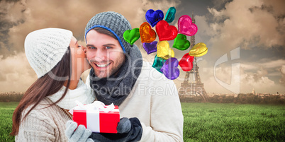 Composite image of winter couple holding gift