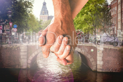 Composite image of happy senior couple holding hands