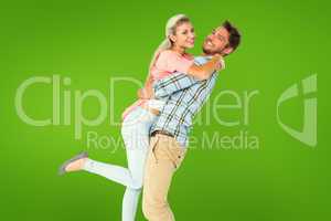 Composite image of handsome man picking up and hugging his girlf