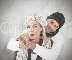 Composite image of smiling couple in winter fashion posing